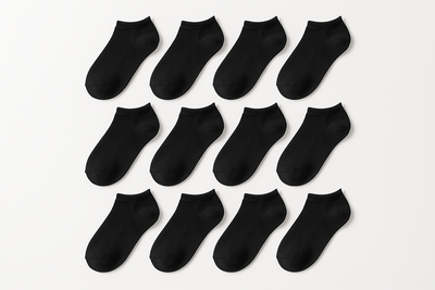 12 pairs of plain black low cut socks on white background
